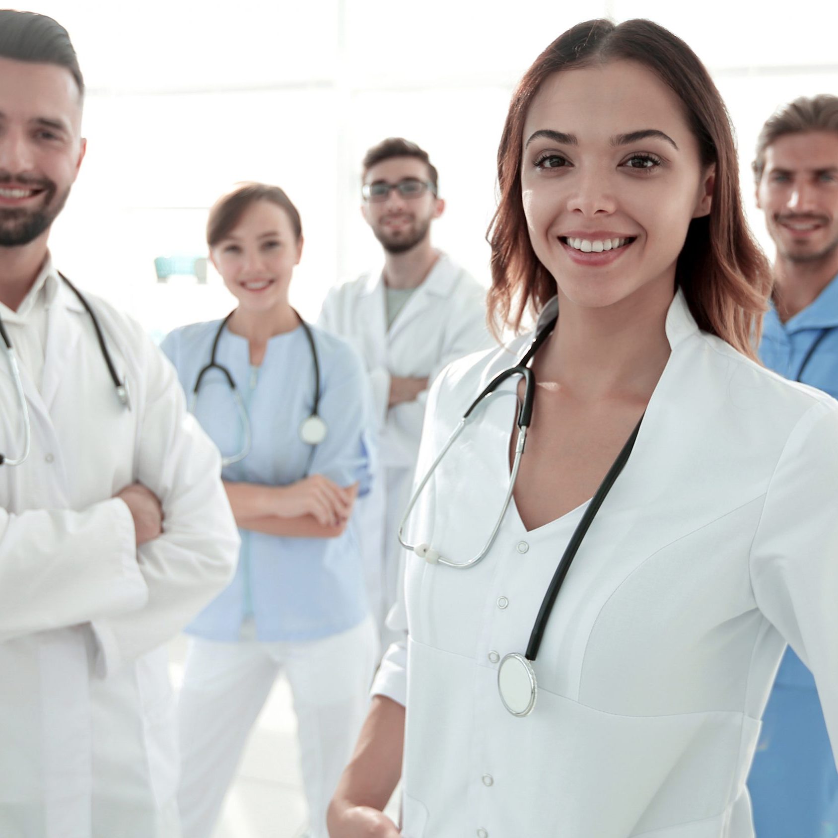 Attractive female doctor with medical stethoscope in front of medical group.photo with copy space